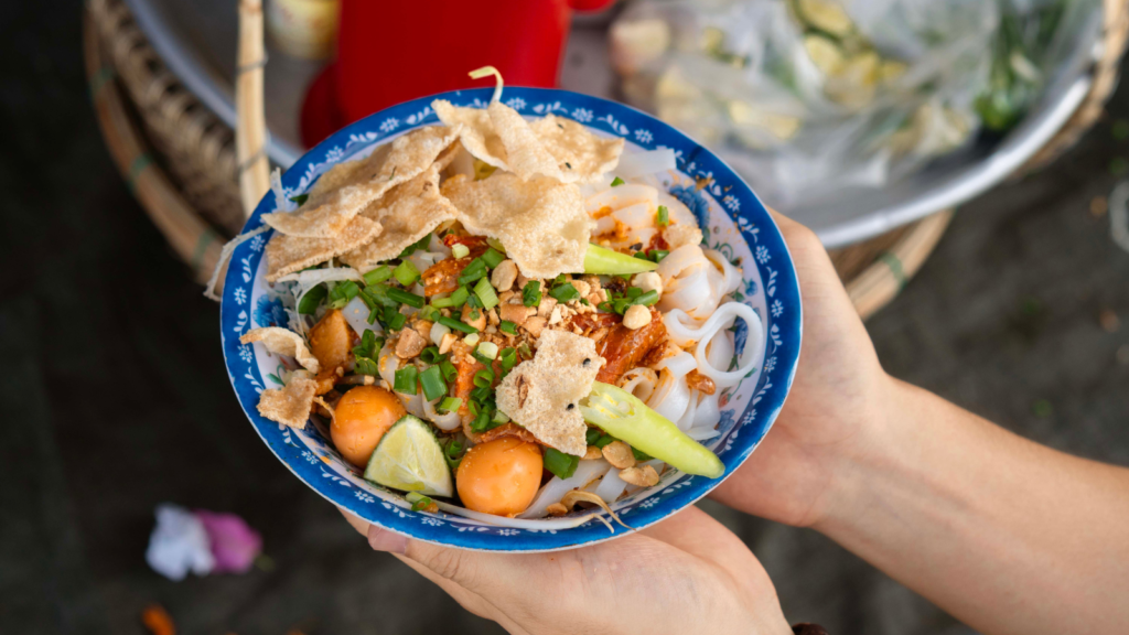 A bowl of Quang noodles at a food stall in Hoi An Market.