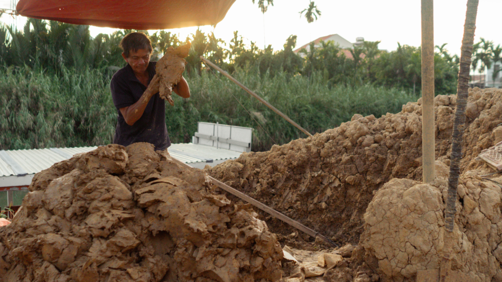Thanh Ha pottery artisan preparing clay