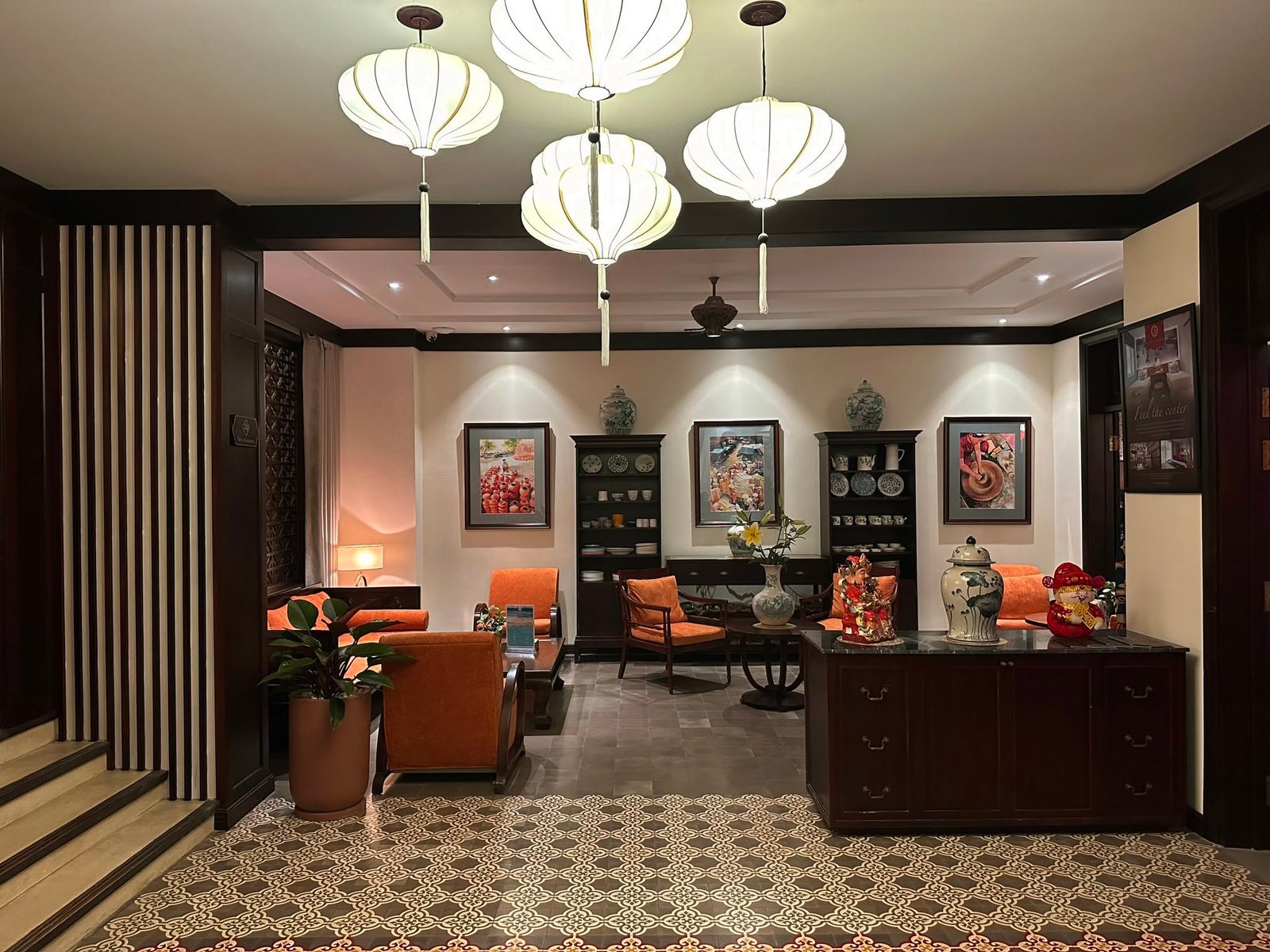 Heritage-inspired lobby lounge with lanterns and elegant seating at Little Hoi An