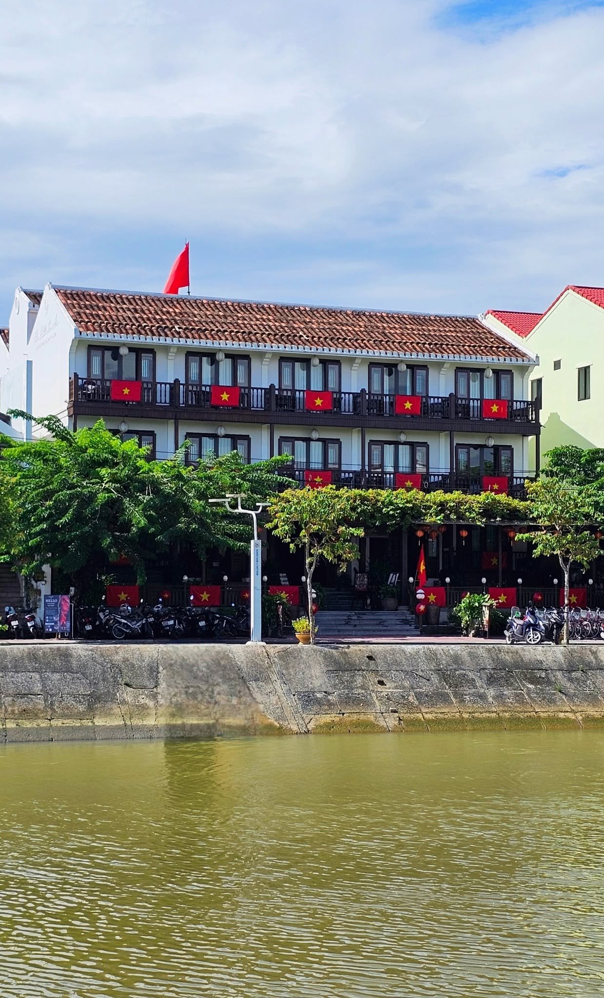 Little Hoi An hotel facade viewed from across the Hoai River