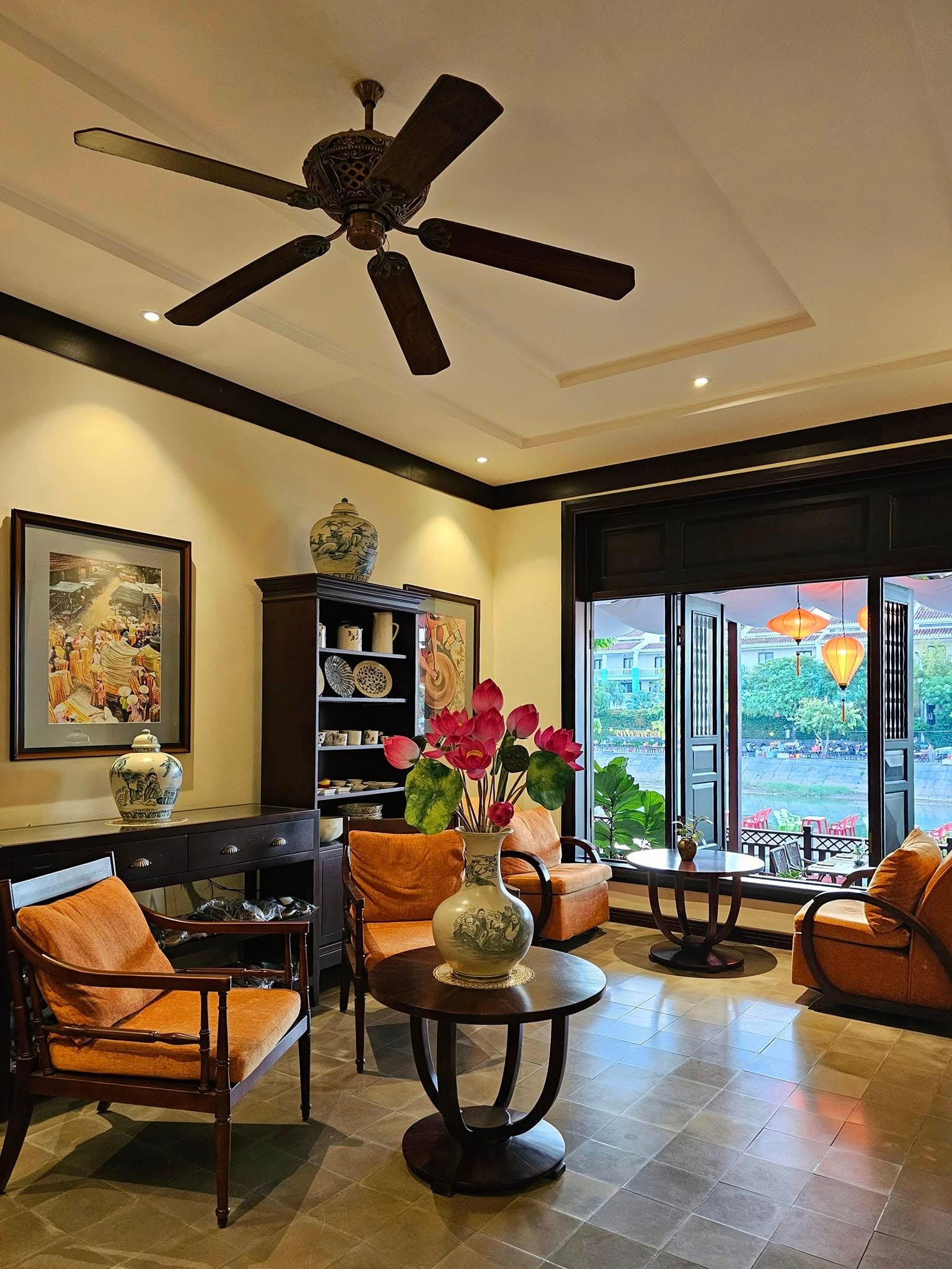 River-facing lobby lounge with warm seating at Little Hoi An