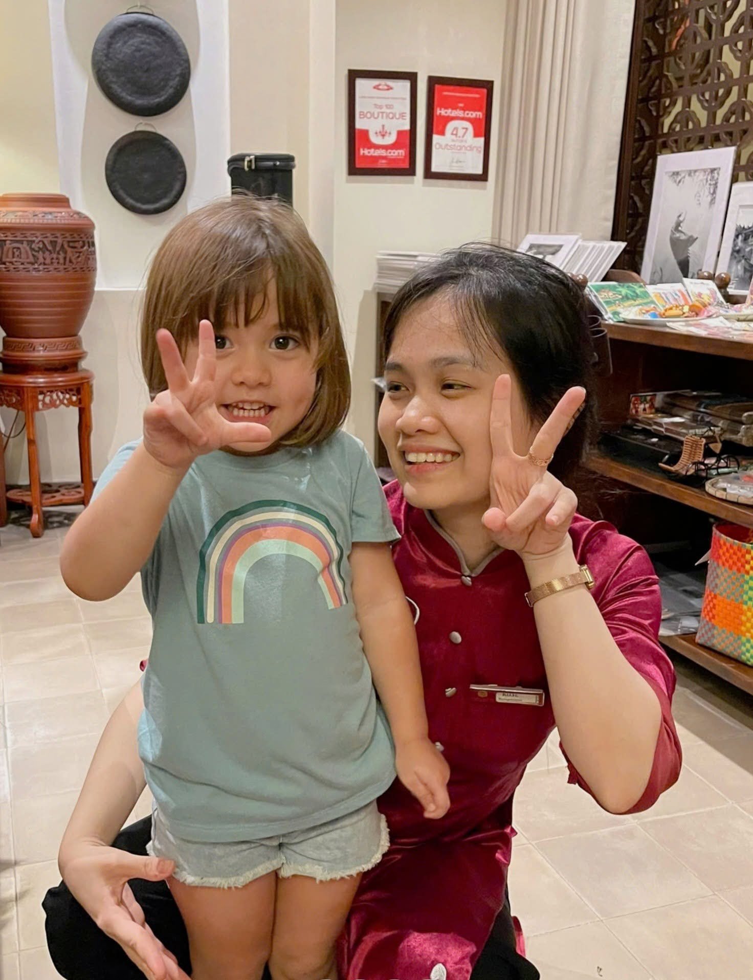 Little Hoi An team member welcoming a young guest with a smile