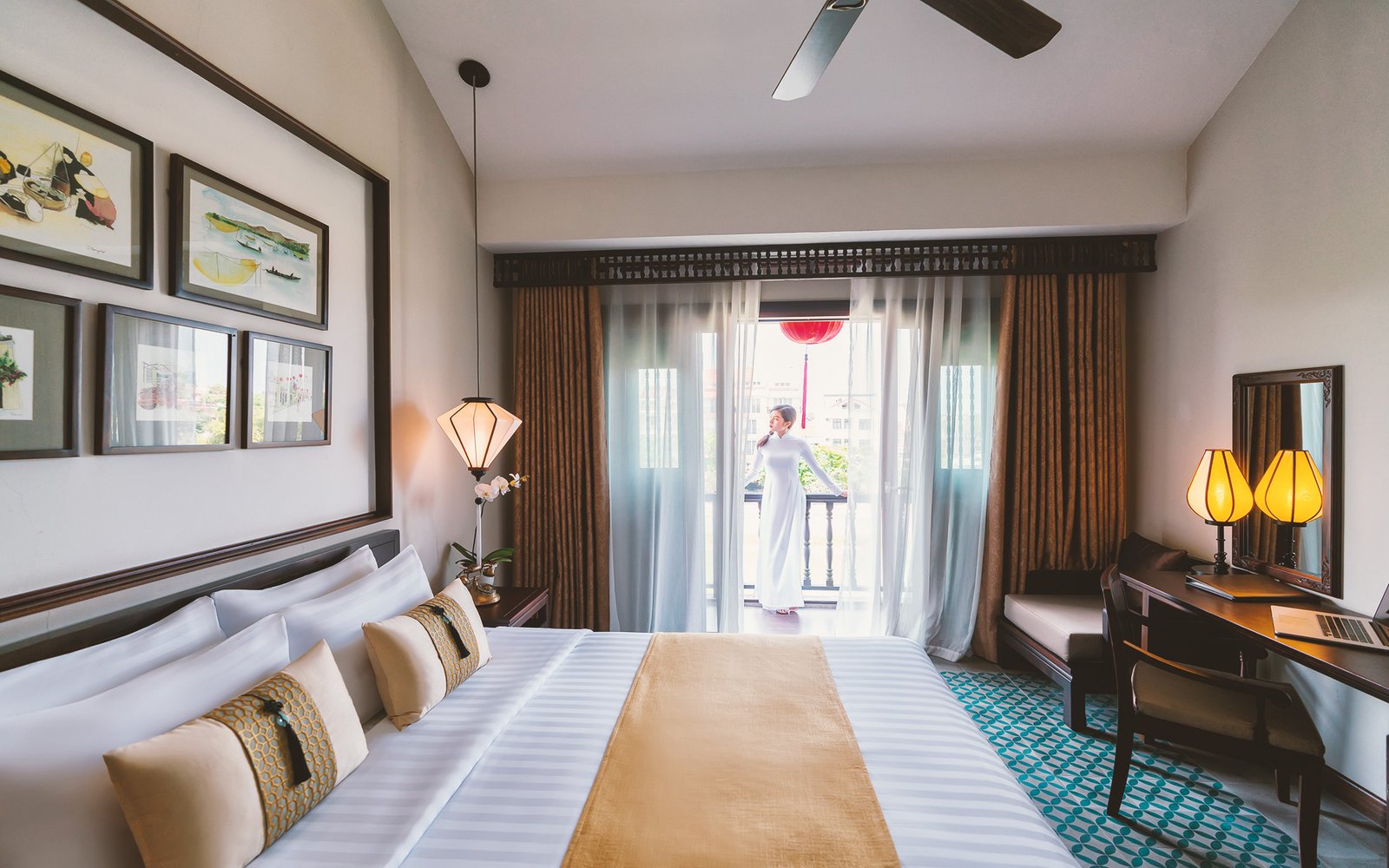 Little Suite bedroom opening onto a Hoai River view balcony