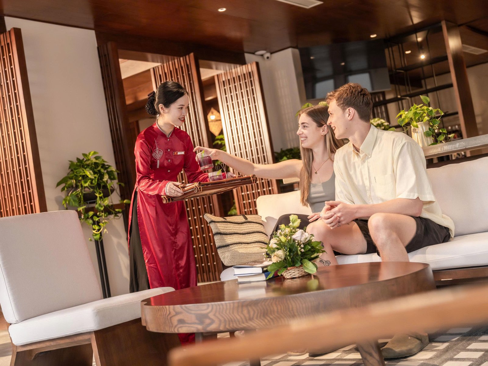Guests enjoying welcome drinks in the Little Oasis lobby lounge