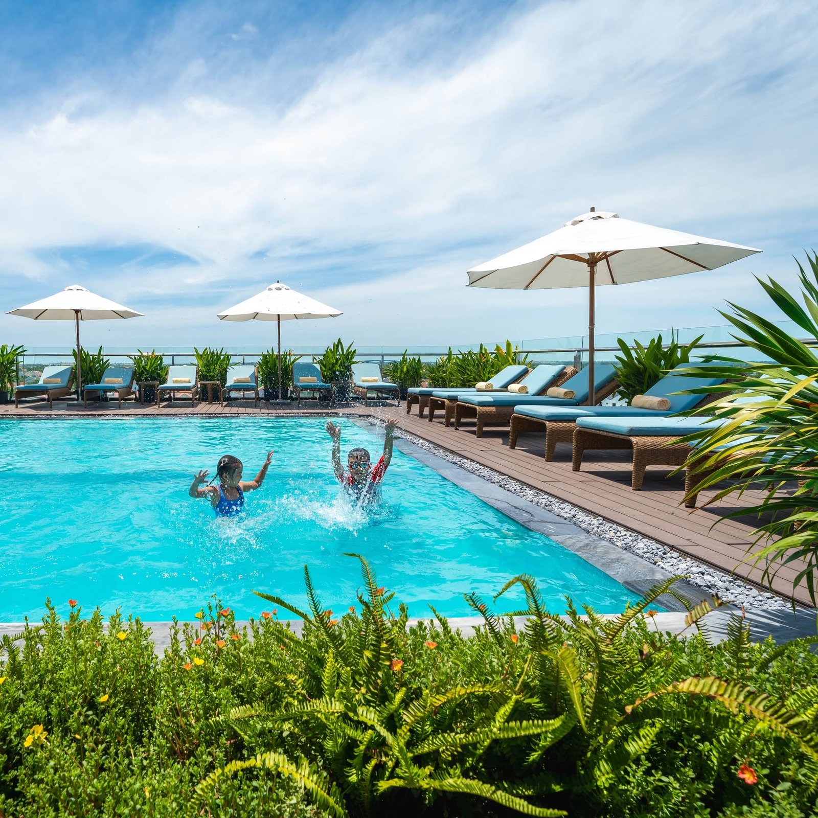 Children enjoying the outdoor swimming pool at Little Oasis Hoi An
