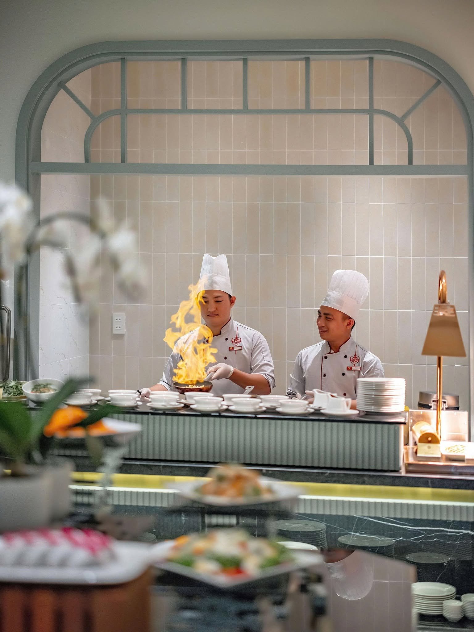 Chefs preparing dishes at the live cooking station