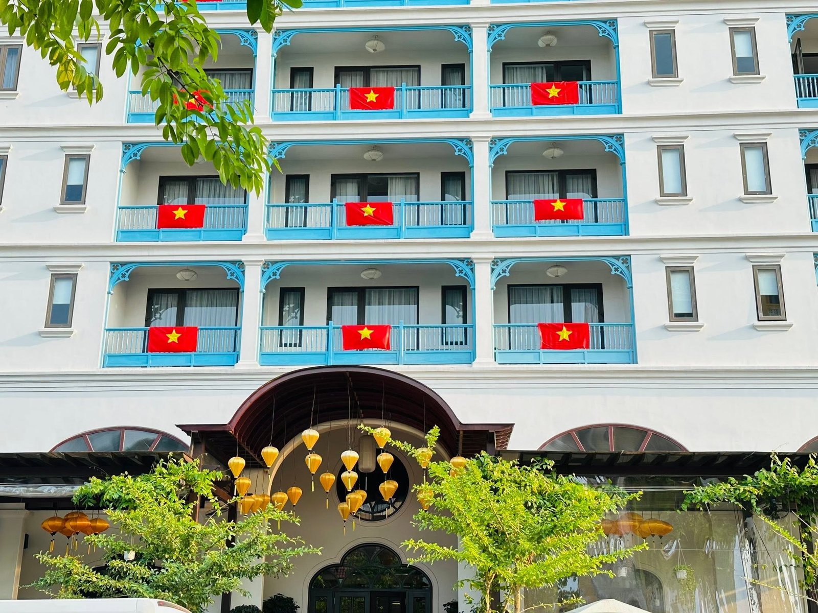 Little Residence Hoi An facade decorated with Vietnamese flags