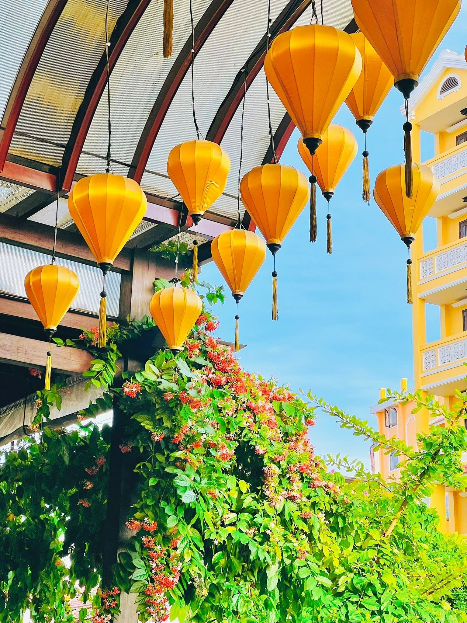 Yellow Hoi An lanterns above the garden at Little Residence
