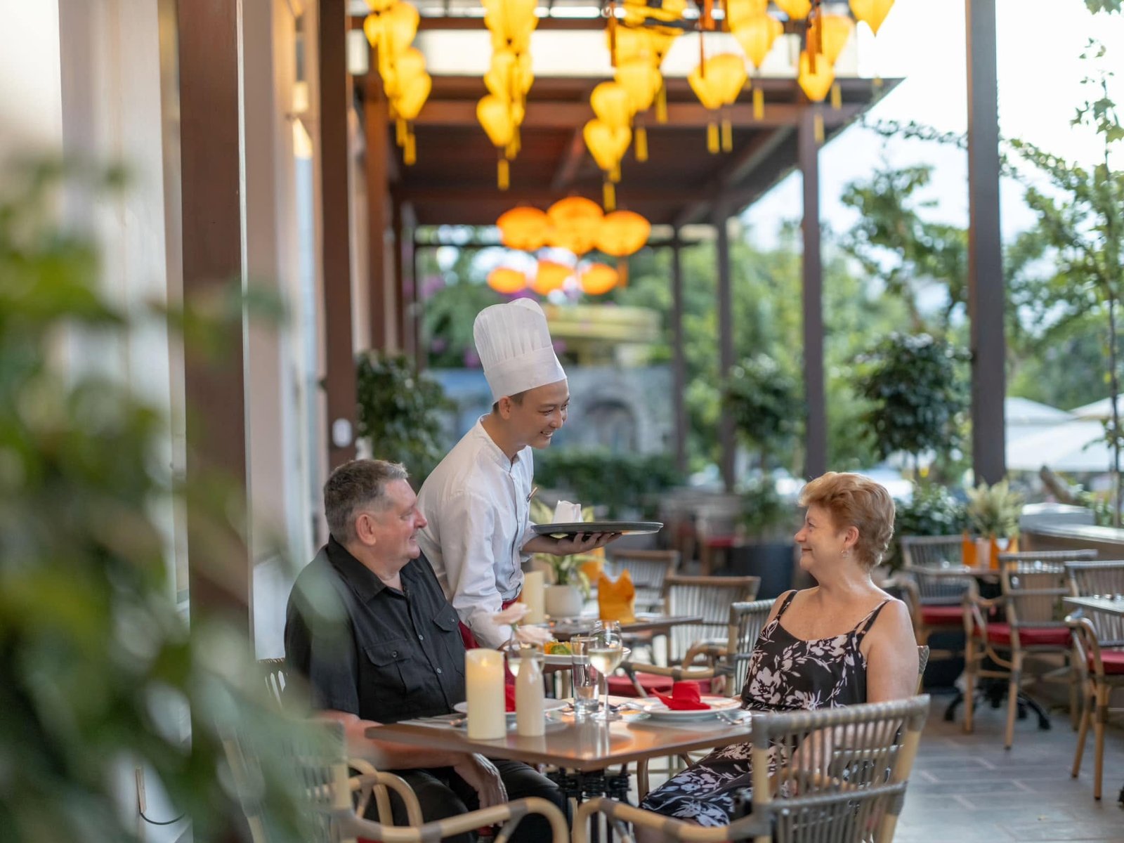 Chef providing warm table service to guests
