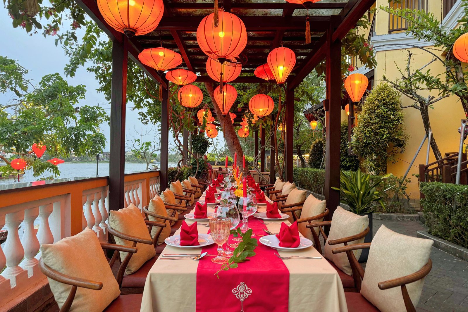 Lantern-lit banquet table on the riverside terrace