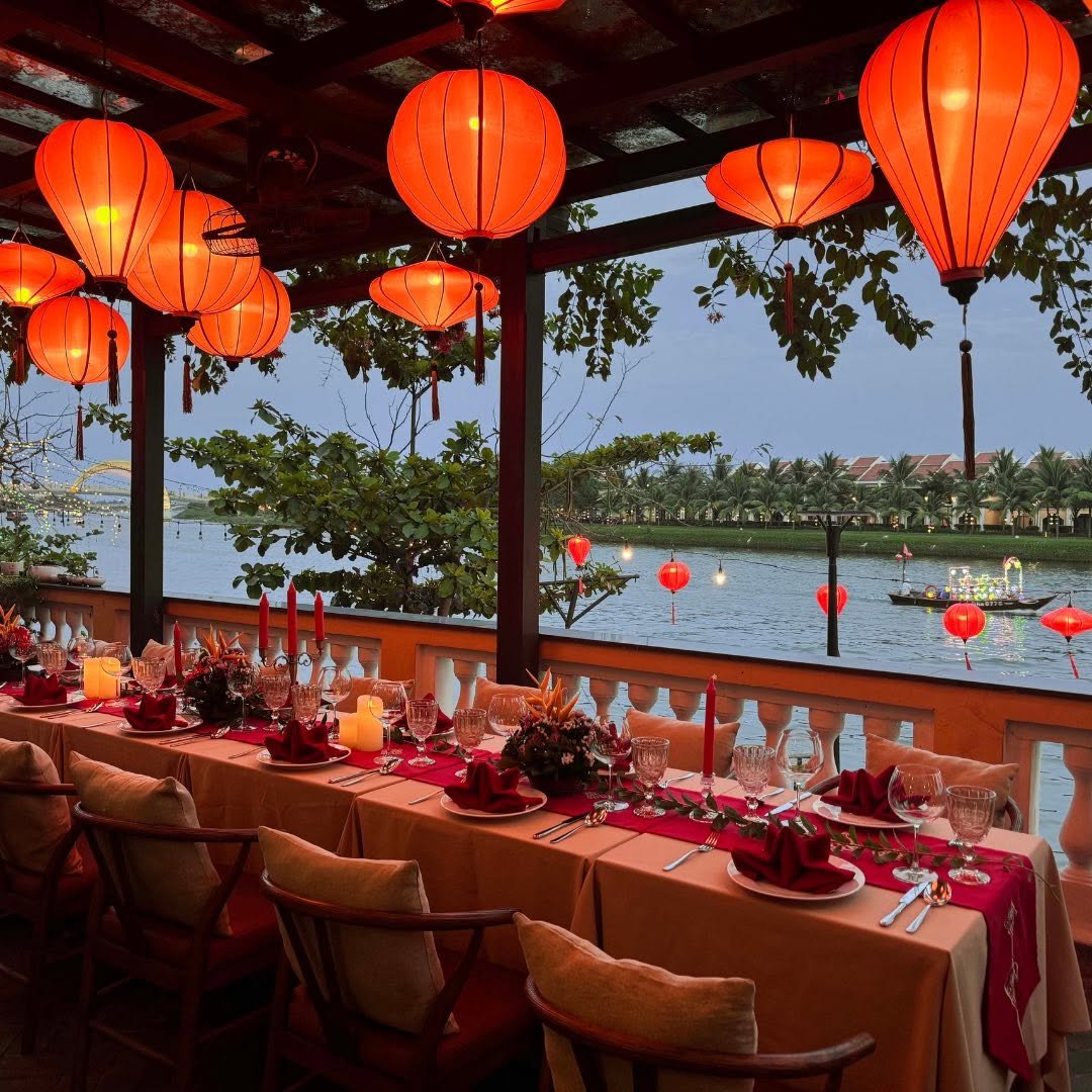 Romantic lantern-lit dinner setup beside the river
